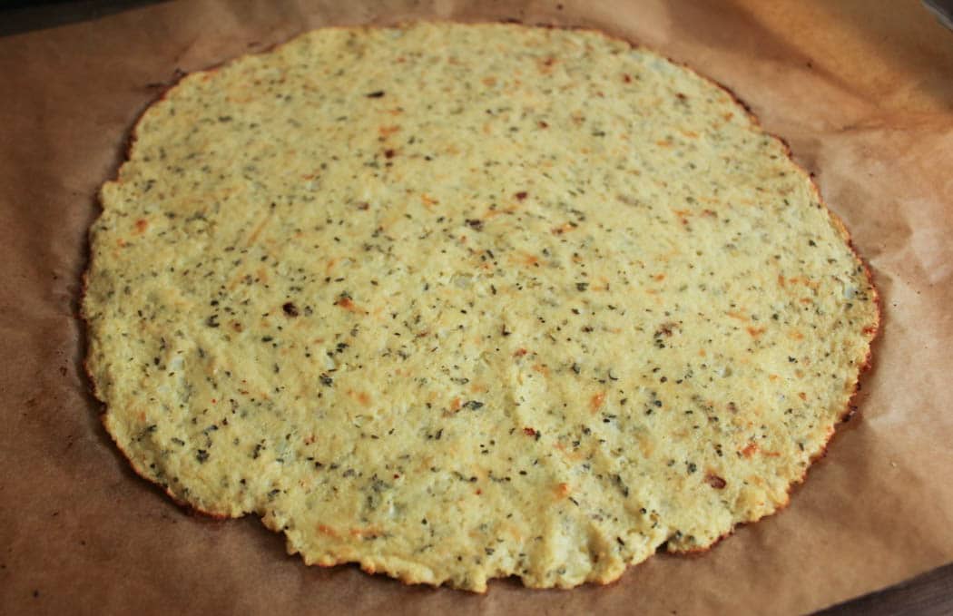 Plain baked cauliflower pizza crust before sauce and topppings