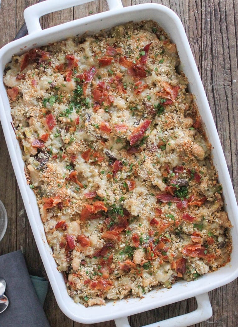 Overhead view of Brown Rice Casserole with Mushrooms, White Beans and Bacon in a casserole dish. 