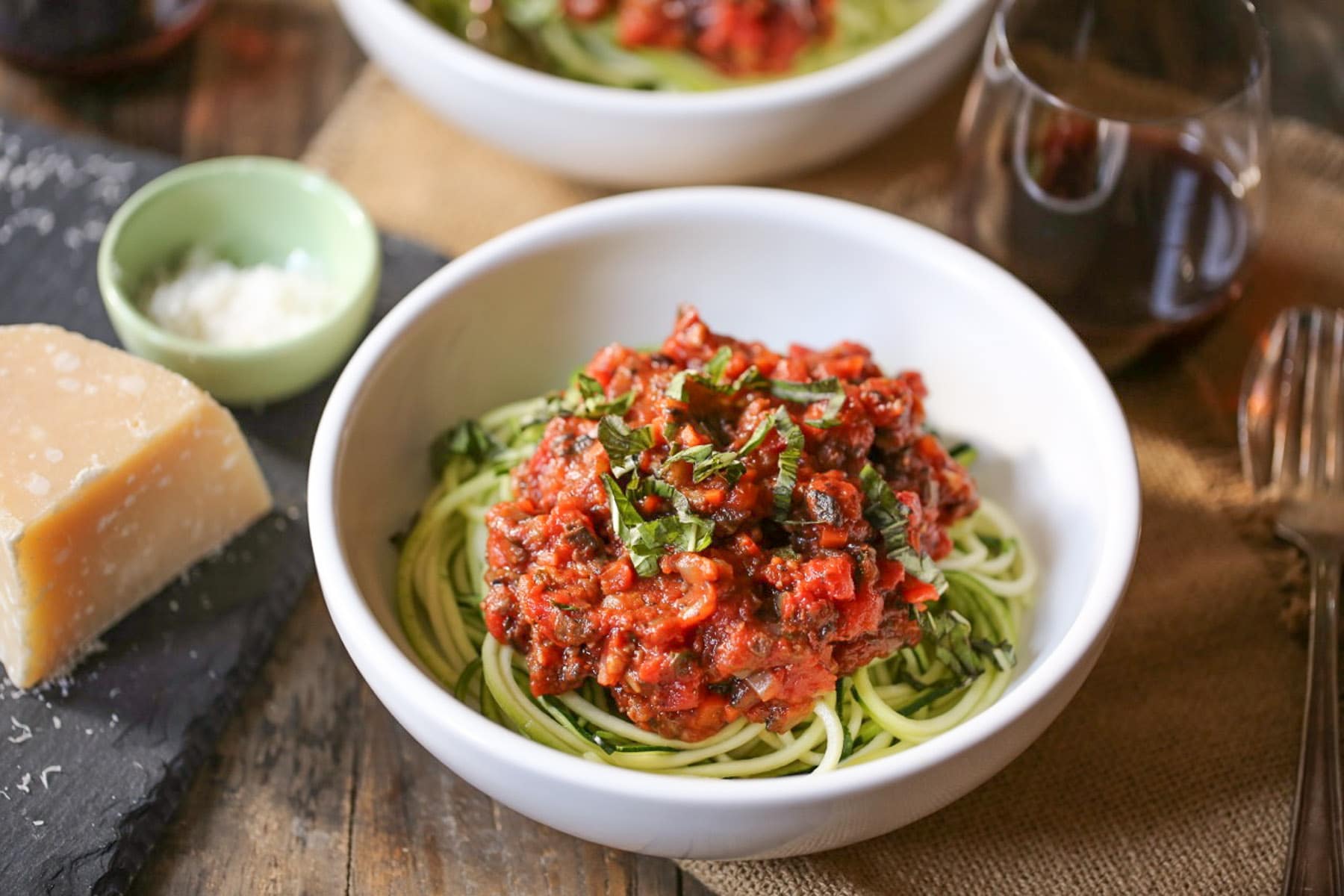 Plated zucchini noodles with portobello bolognese and wine