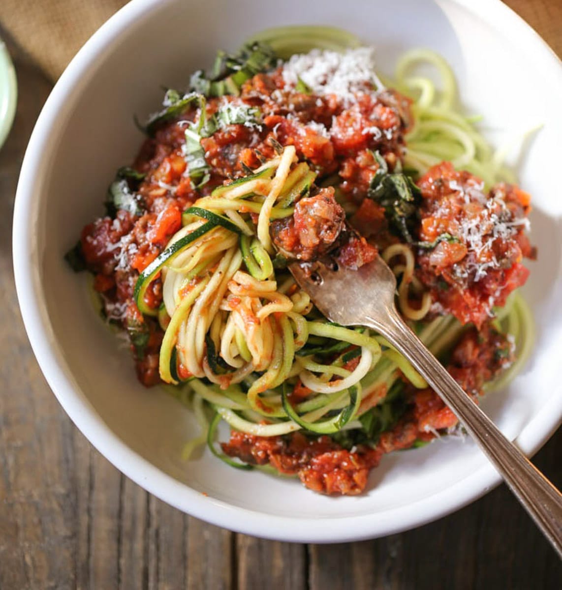 Zucchini noodles twisted around a fork with portobello bolognese
