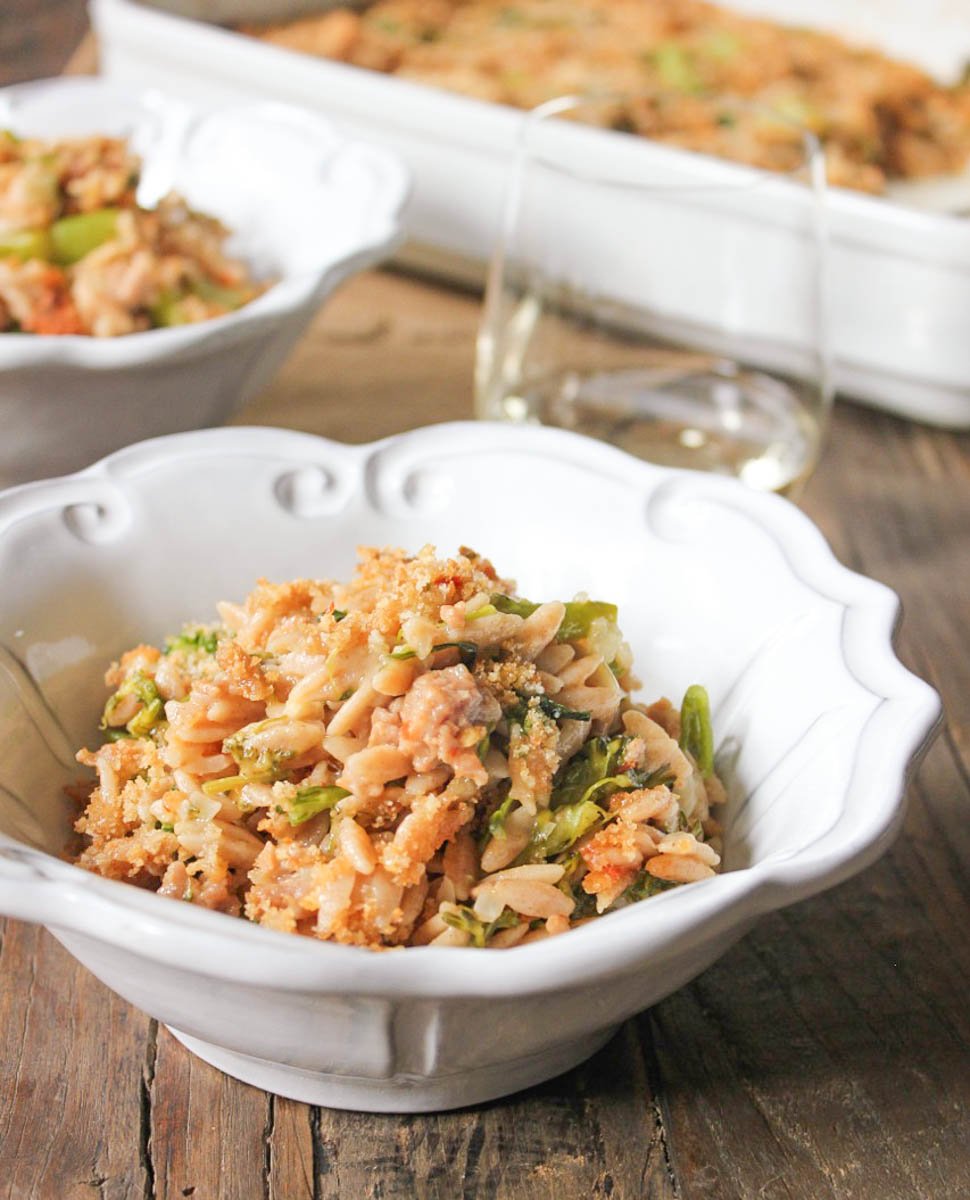 Two plated bowls of Baked Orzo with Broccolini, Sausage and Fontina.