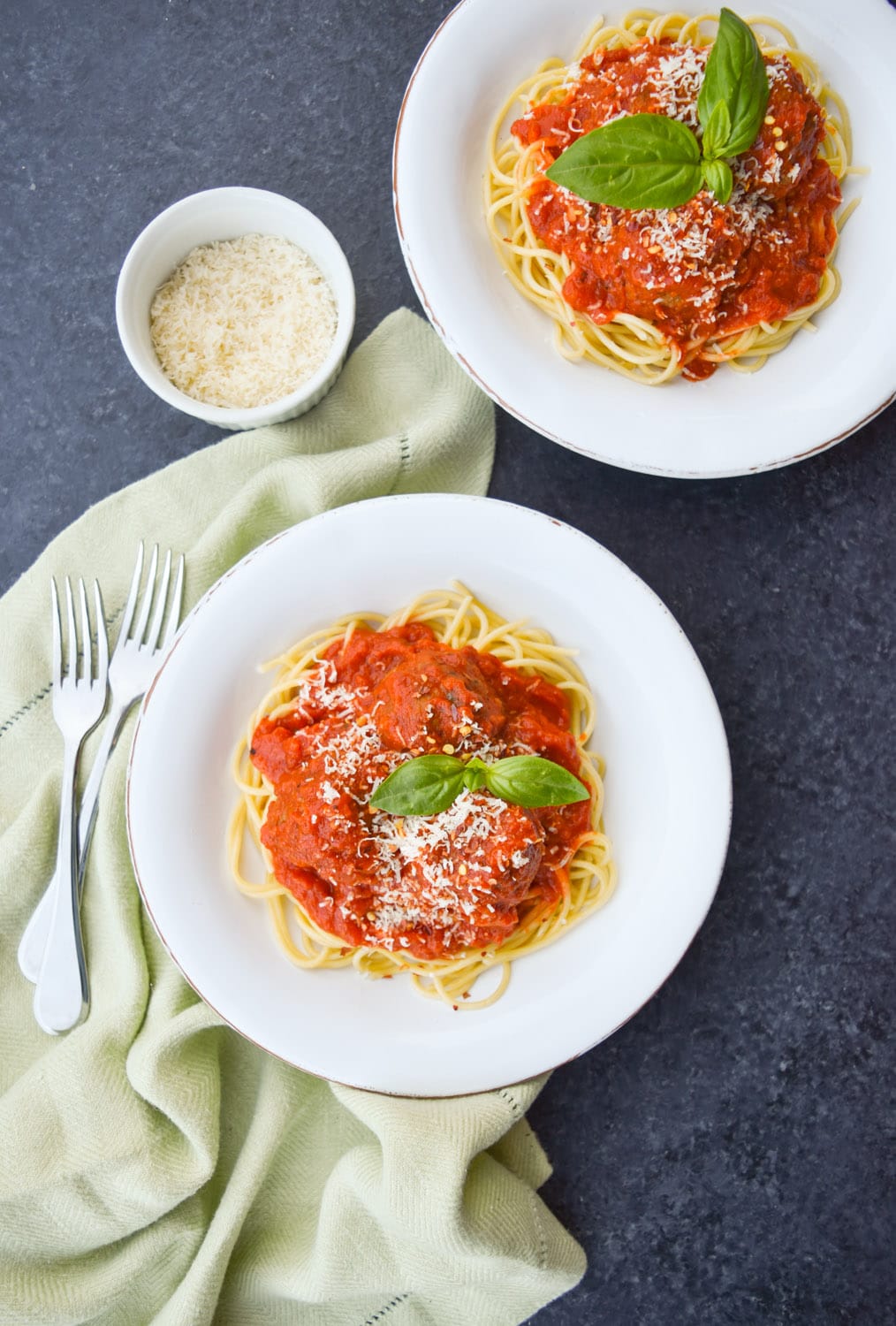 Two plated servings of easy spaghetti and meatballs with Rao's marinara sauce.