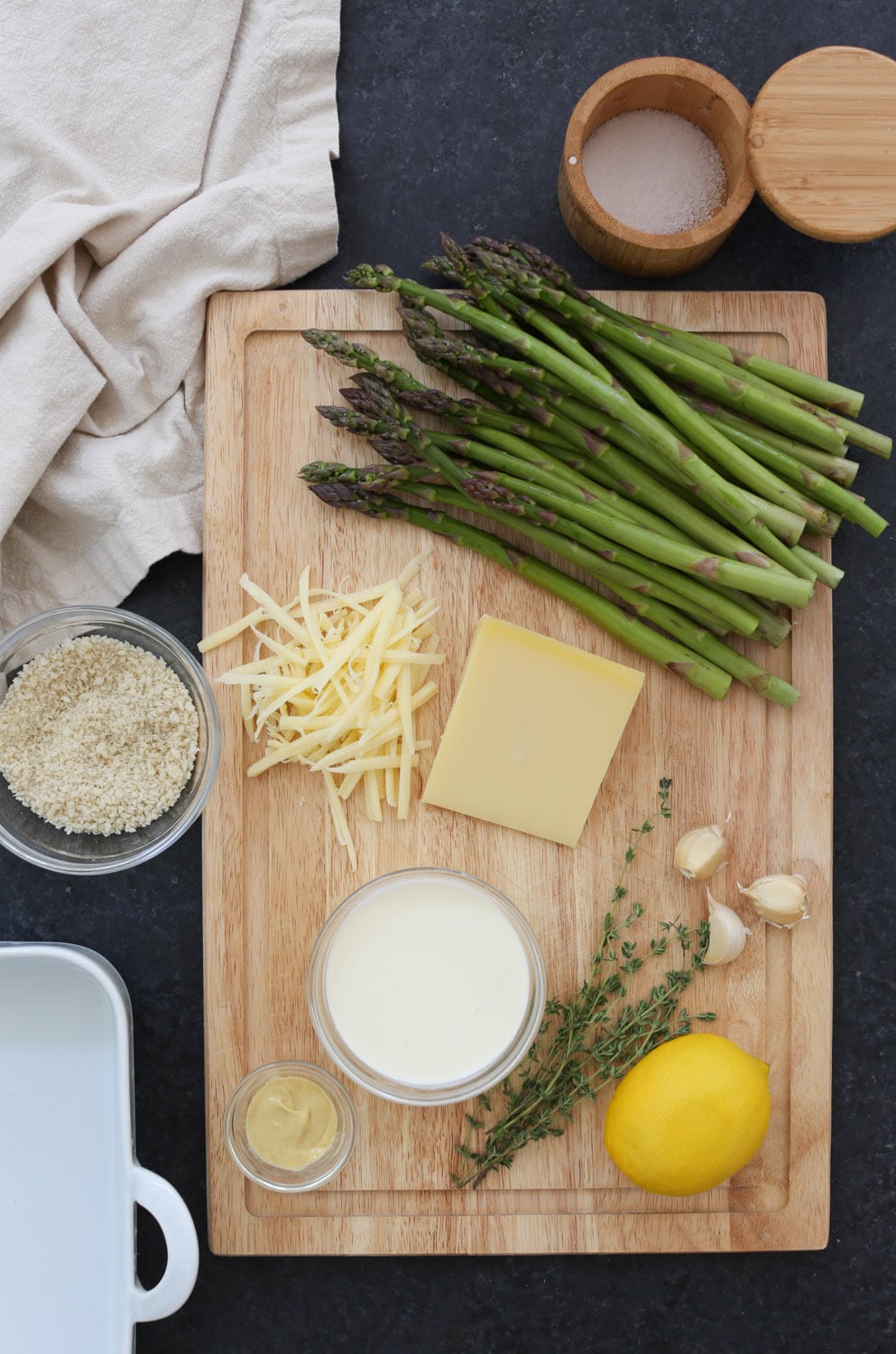 Overhead view of all ingredients for asparagus gratin.
