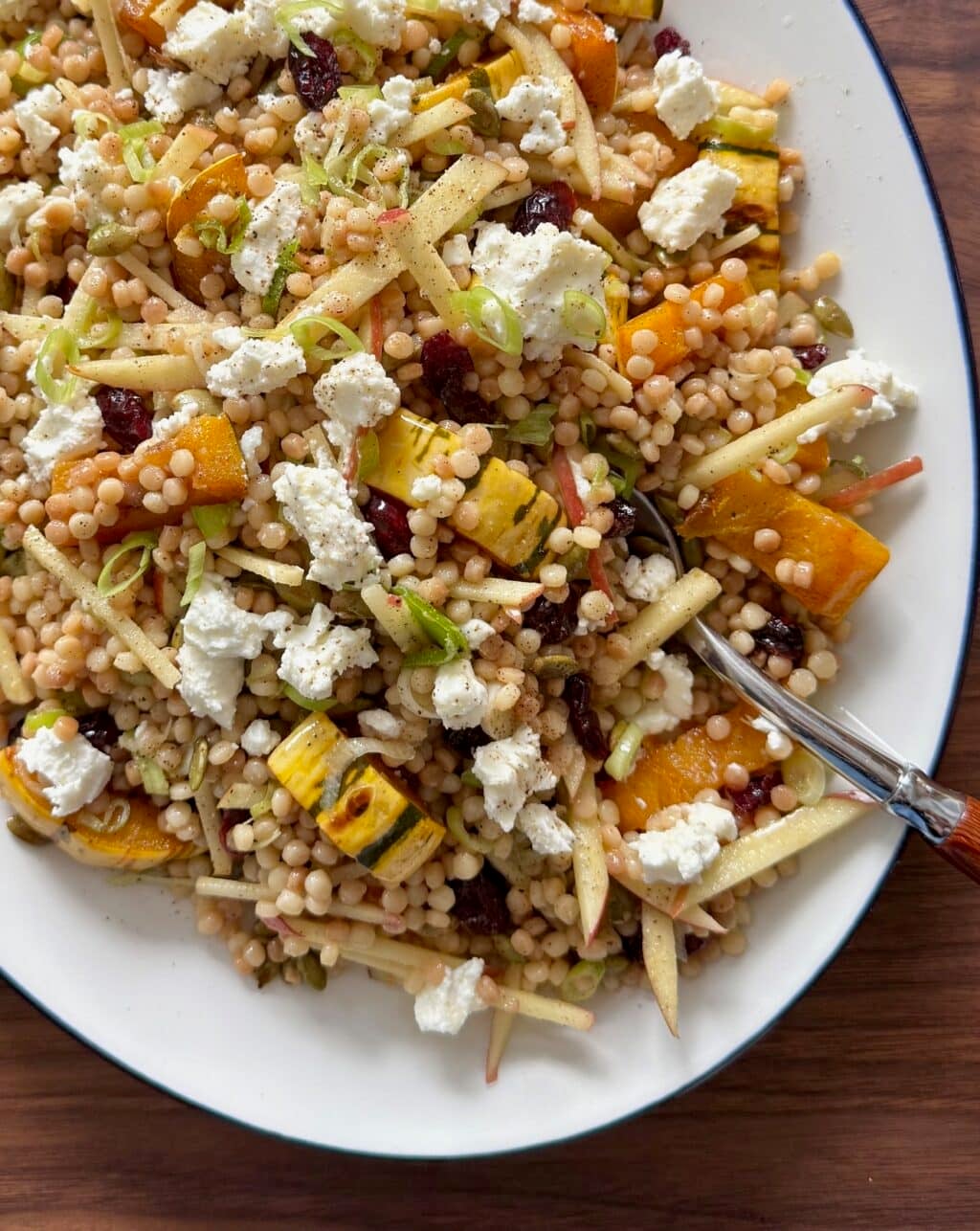 This is a close up of the fall couscous salad with delicata squash, apple, and cranberries.